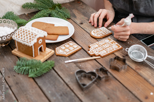Christmas homemade gingerbread cookies on wooden table. Icing of Christmas bakery. closeup, copy space. Blank biscuit gingerbread house, ready to decorate.