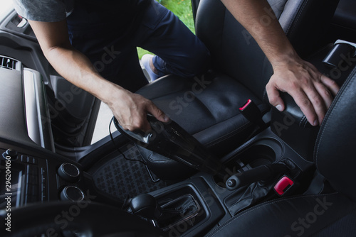 cropped view of car cleaner vacuuming car interior