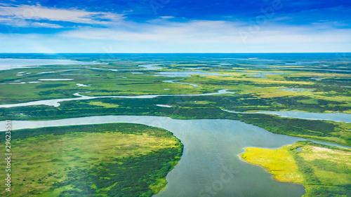 Landscape of the arctic tundra in summer. Rivers, lakes, northern vegetation. View from above. The concept of climate change, warming in the Arctic.