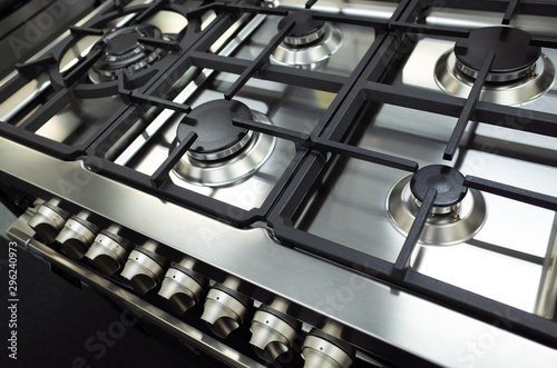 Close up of a brand new and clean stainless steel stove top/hop or a gas cooktop.