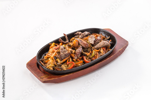 Beef fajitas with colorful vegetables in pan isolated on white background