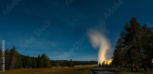 Eruption of Old Faithful geyser at Yellowstone National Park at night