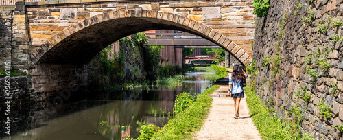 Woman walking down canal toepath in Georgetown, DC
