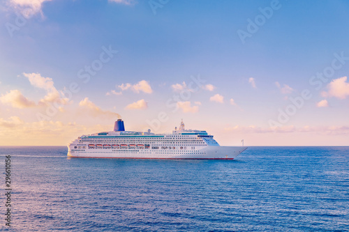 Luxury cruise ship sunset in blue sea with clouds