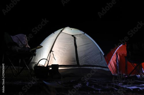 Modern camping tents in wilderness at night