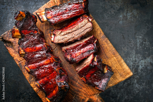 Barbecue chuck beef ribs with hot marinade as top on a wooden cutting board with copy space right