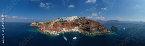 Aerial drone panoramic photo of traditional and picturesque village of Oia in volcanic island of Santorini, Cyclades, Greece