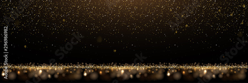 Gold glitter and shiny golden rain on black background. Vector horizontal luxury background.