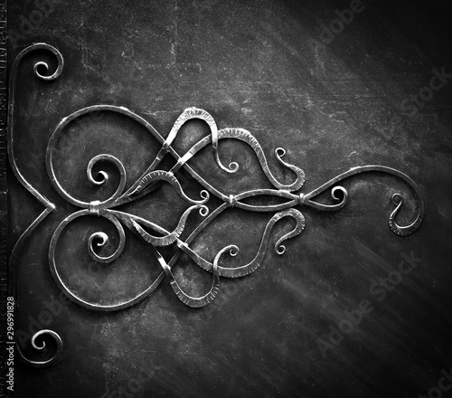 Metal forged gate elements, in dark tones.