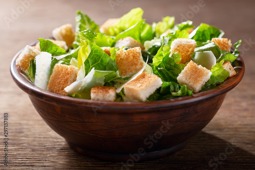 Bowl of caesar salad with cheese and croutons