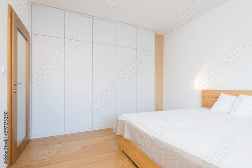 White wooden closet in bedroom of contemporary apartment