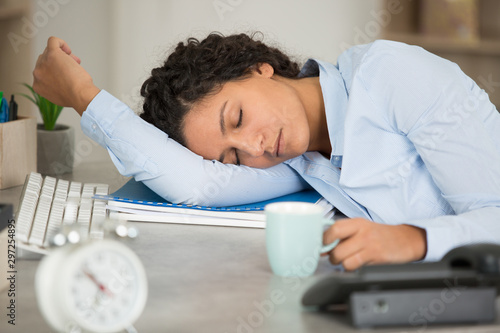 woman fallen asleep at her office desk