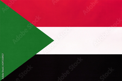 Republic of Sudan national fabric flag, textile background. Symbol of world African country.