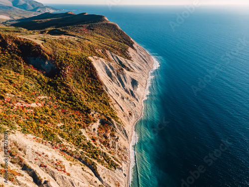 Aerial view of rocky cliff, coastline and sea with wave in Anapa