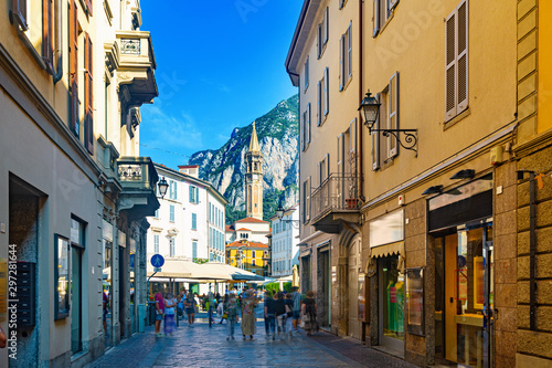Lecco street with bell-tower of Basilica
