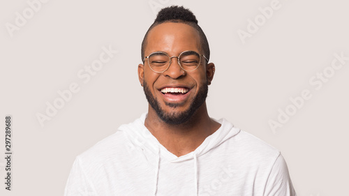 Headshot of happy biracial man smiling showing healthy teeth