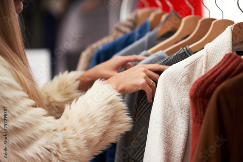 Adult women shopping for clothes in boutique in autumn