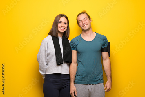 Group of athletes over yellow background smiling
