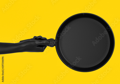 Black hands holding pan isolated on yellow, top view, abstract illustration of cooking process, fry something promo banner concept. 3d rendering