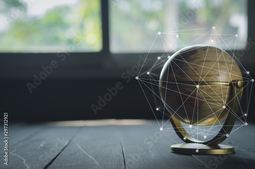 spinning globe on black table with hand drawing grid line