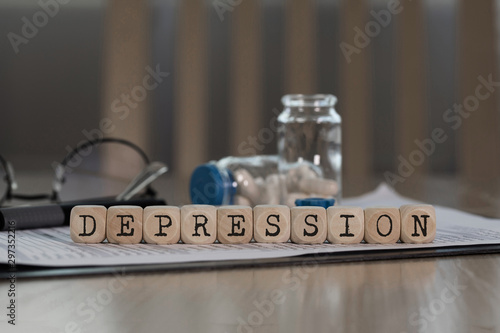 Word DEPRESSION composed of wooden dices.