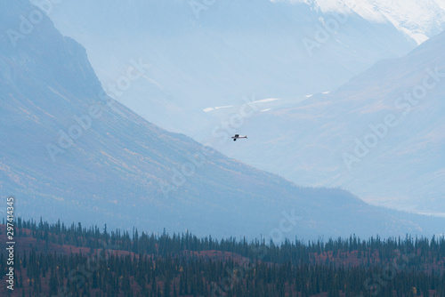 Plane flying in remote mountains in Alaska