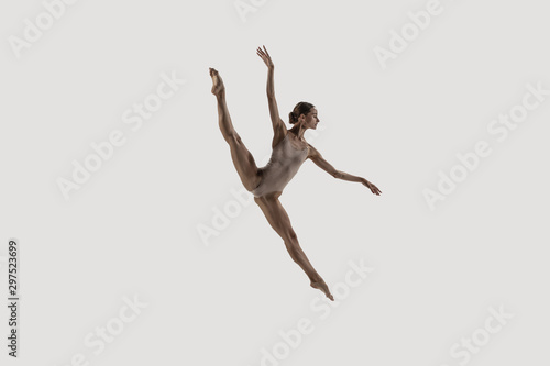 Modern ballet dancer. Contemporary art ballet. Young flexible athletic woman.. Studio shot isolated on white background. Negative space.