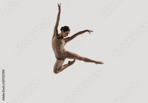 Modern ballet dancer. Contemporary art ballet. Young flexible athletic woman.. Studio shot isolated on white background. Negative space.