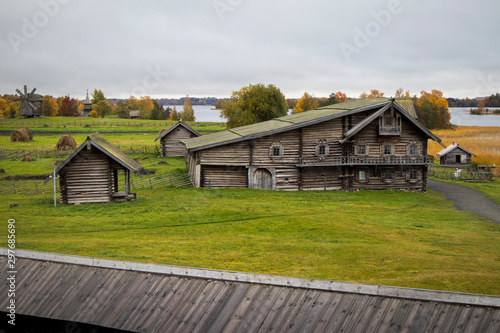 Karelia, Russia - august 27, 2019: Sunset landscape with view of the Transfiguration Church and farm house on the island of Kizhi, Karelia region, Russia in raining