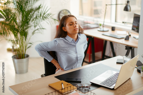 Young businesswoman having backache