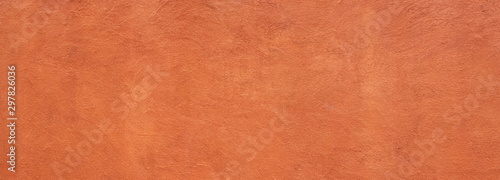 Abstract panorama image of Orange clay wall grunge texture background for interior decoration.