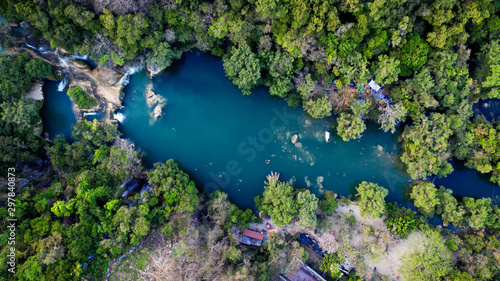 Beautiful Lake at San Luis Potosí in Huasteca Potosina, Mexico. Aerial drone photo of pond surrounded by forest full of green trees.