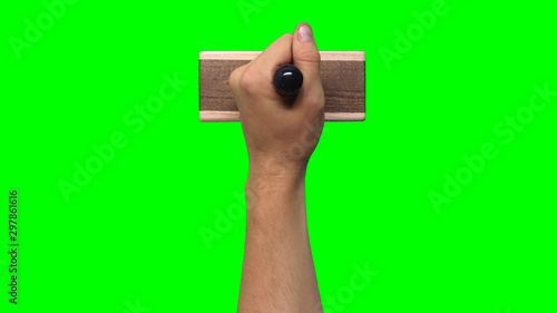 Hand Holding Large Stamp on Chroma Key Green Background 