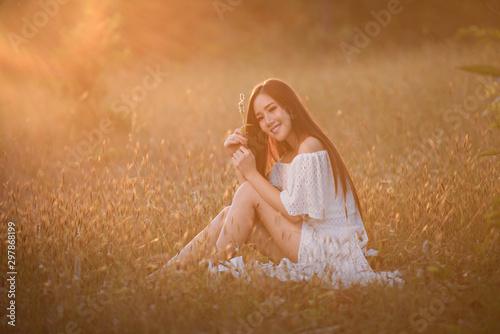 Beautiful woman with the meadow and sunset.