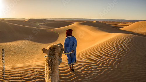 tourist in sahara morocco desert walking in dune landscape