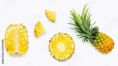 Fresh whole and cut pineapple isolated on white