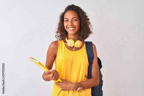 Brazilian student woman wearing backpack holding notebook over isolated white background with a happy face standing and smiling with a confident smile showing teeth