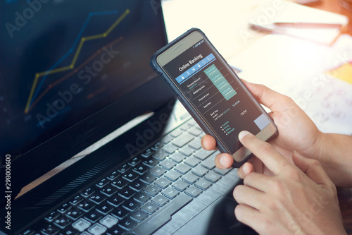 Businessman using mobile smartphone with data information banking network connection on screen, mobile banking and online payment.