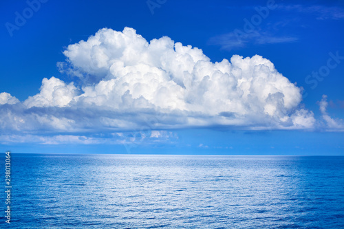 White cumulus clouds in blue sky over sea landscape, big cloud above ocean water panorama, horizon, beautiful tropical sunny summer day seascape panoramic view, cloudy weather, cloudscape, copy space