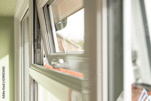 Shallow focus of CE marking seen within newly installed double glazed windows. The mechanism for the small window can be seen, which is located at the back of the house.