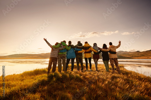 Happy big family hugging together in mountains