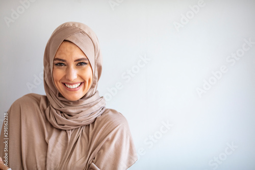 Modern, Stylish and Happy Muslim Woman Wearing a Headscarf. Arab saudi emirates woman covered with beige scarf. "Welcome" Face. One women smile with white background