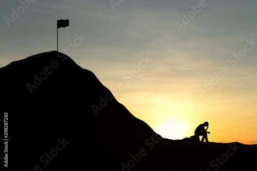 Silhouette man are sad to not be able to climb the mountain. Sky and sunset background. Unsuccessful and fail concept.