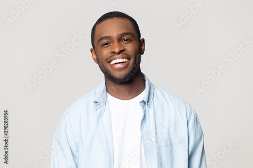 Head shot portrait happy African American man with healthy smile