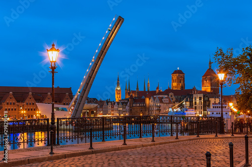 Amazing lights on cityscape of evening Gdansk, view from Wapienny Bridge on bascule footbridge.