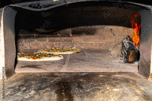 Pizza baking in wood fire oven