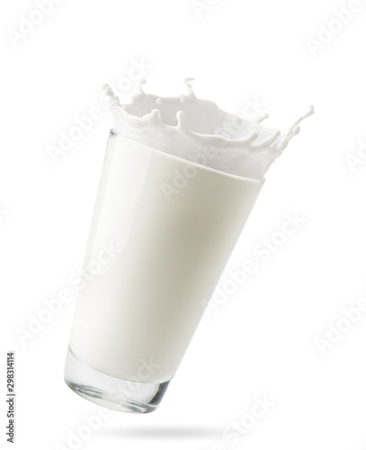 Glass of milk with splashes flies in the air on a white background, isolated.