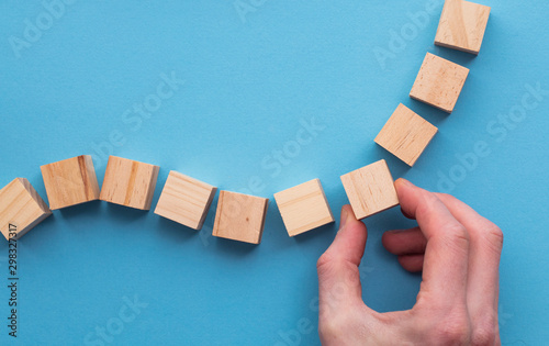 Hand choosing a wooden block from a set. Business choice concept