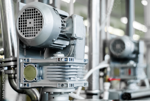 blurred industrial background with electric motor on the foreground