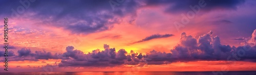 Phuket beach sunset, colorful cloudy twilight sky reflecting on the sand gazing at the Indian Ocean, Thailand, Asia.